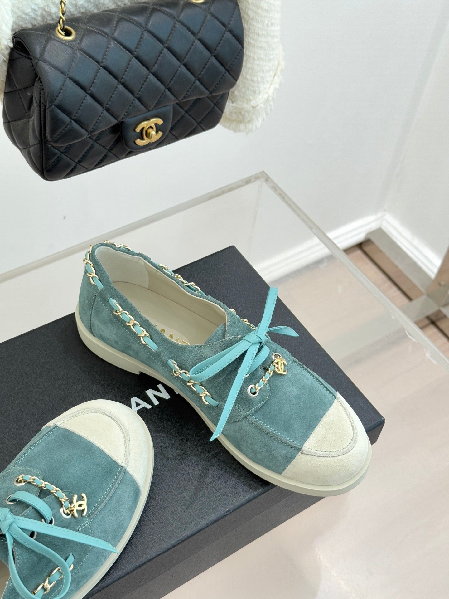 Chanel ladies blue suede sneakers, teal laces with gold chain links, on black box