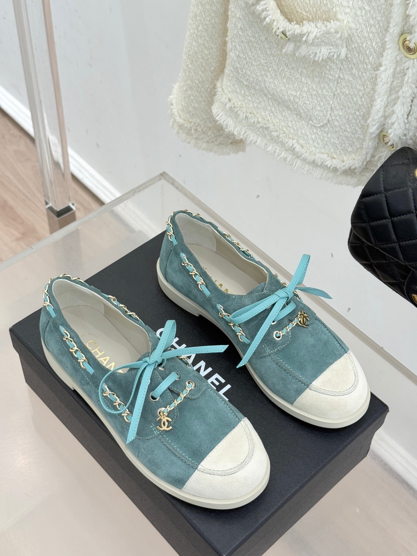 Chanel ladies blue suede sneakers with white side panels, teal laces, gold chain accents
