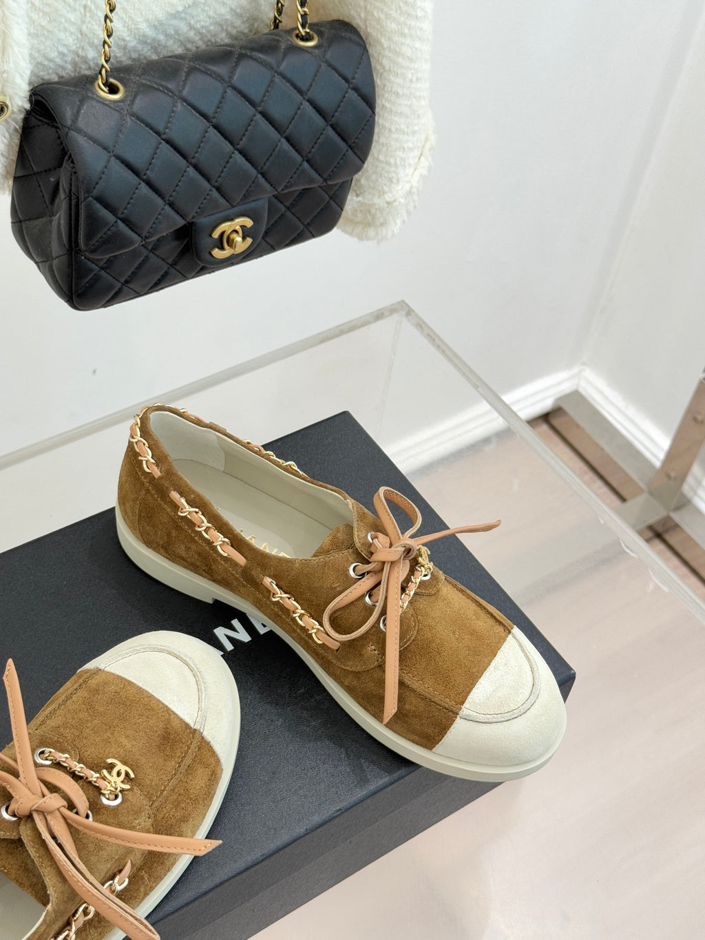 Tan suede lace-up sneakers with white toe panels, pink laces, and white rubber soles