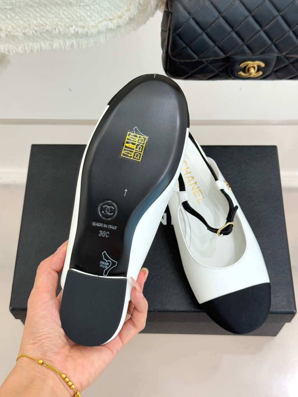 Chanel flat outsole view with black rubber base and white upper trim