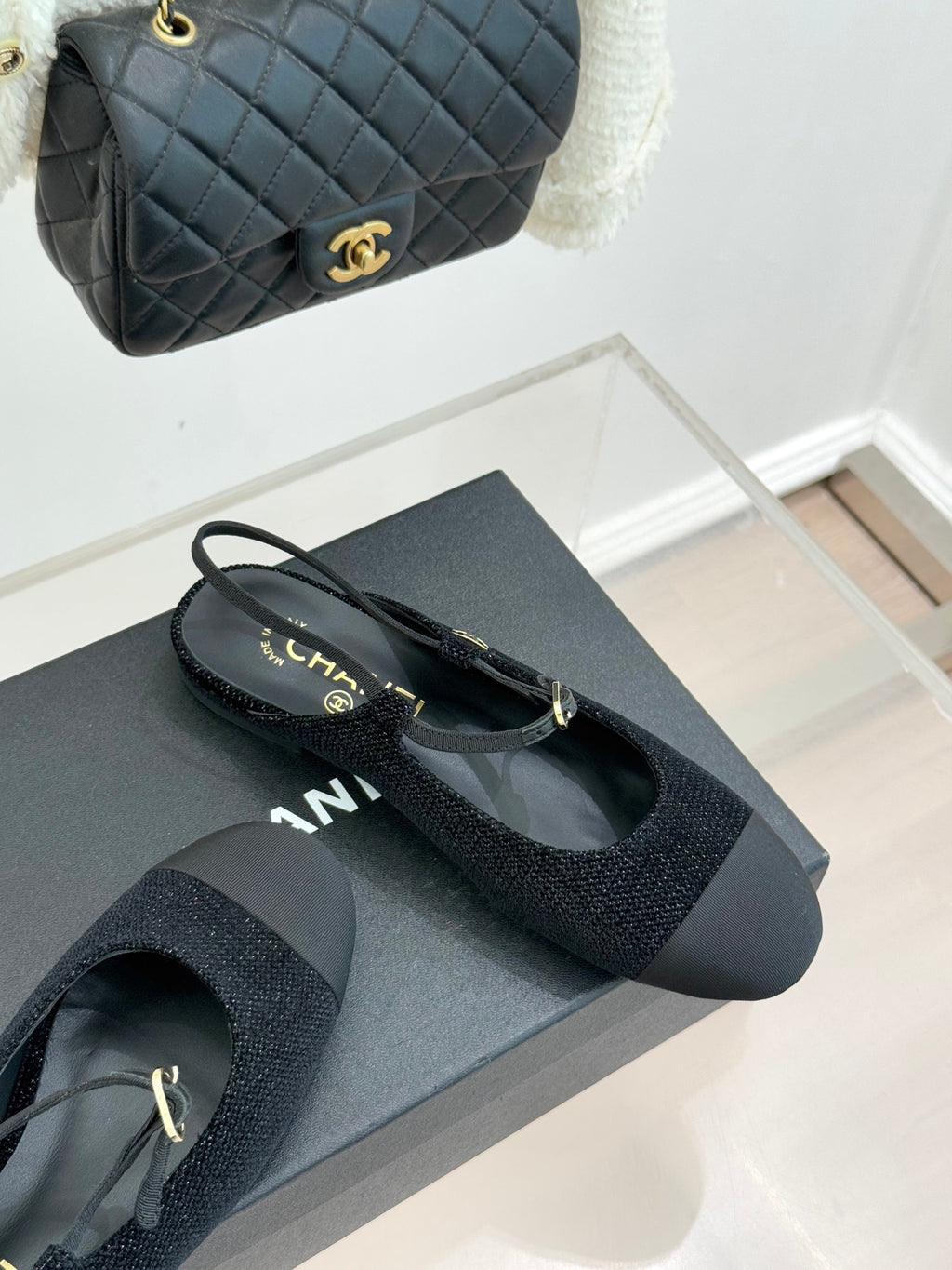 Chanel ladies black slingback flats with gold CC charm and textured mesh upper