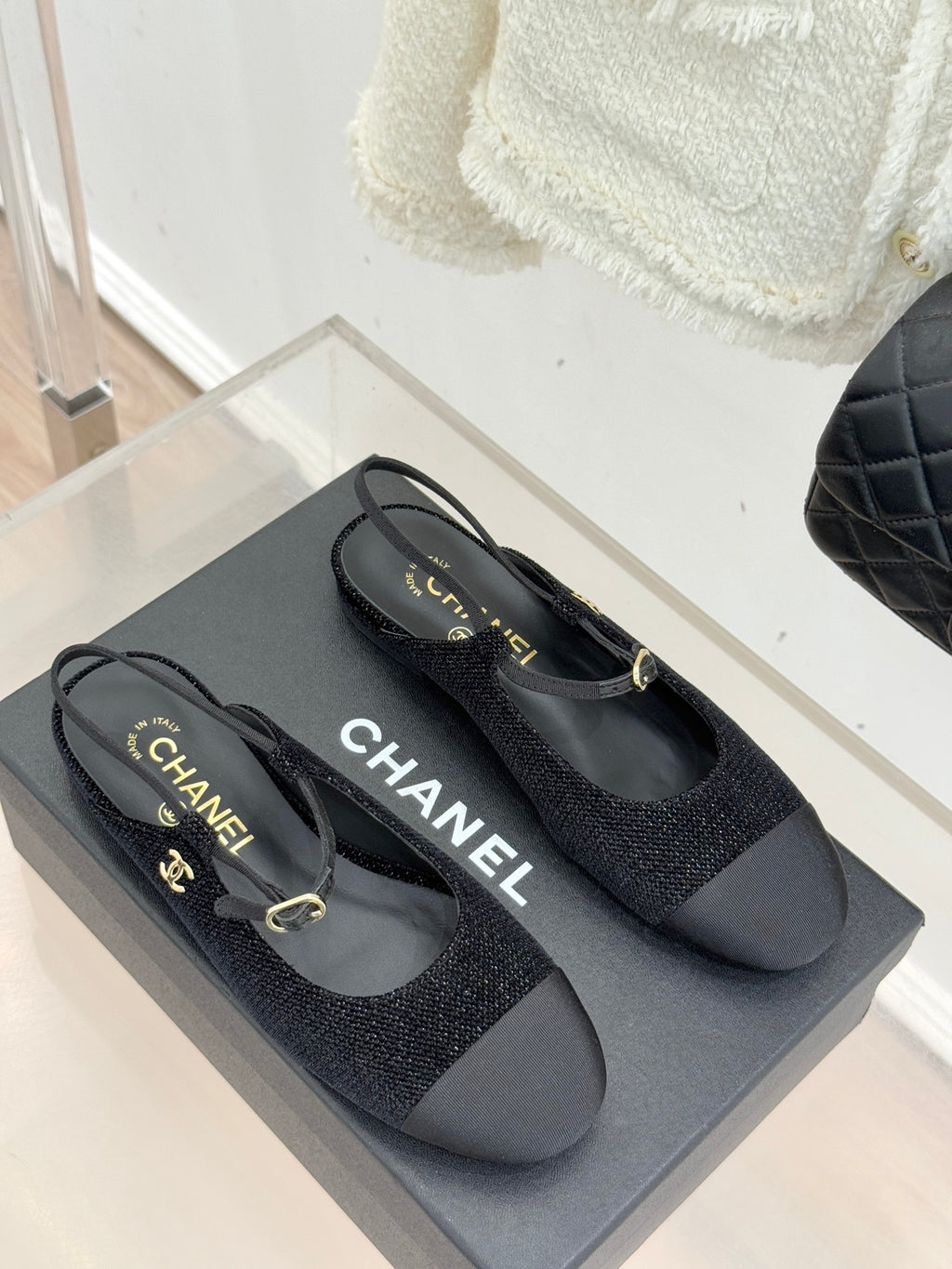 Chanel ladies black slingback flats pair with gold CC accents and engraved heel label