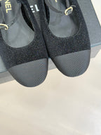Chanel ladies black slingback flats close front view with gold CC charm near strap