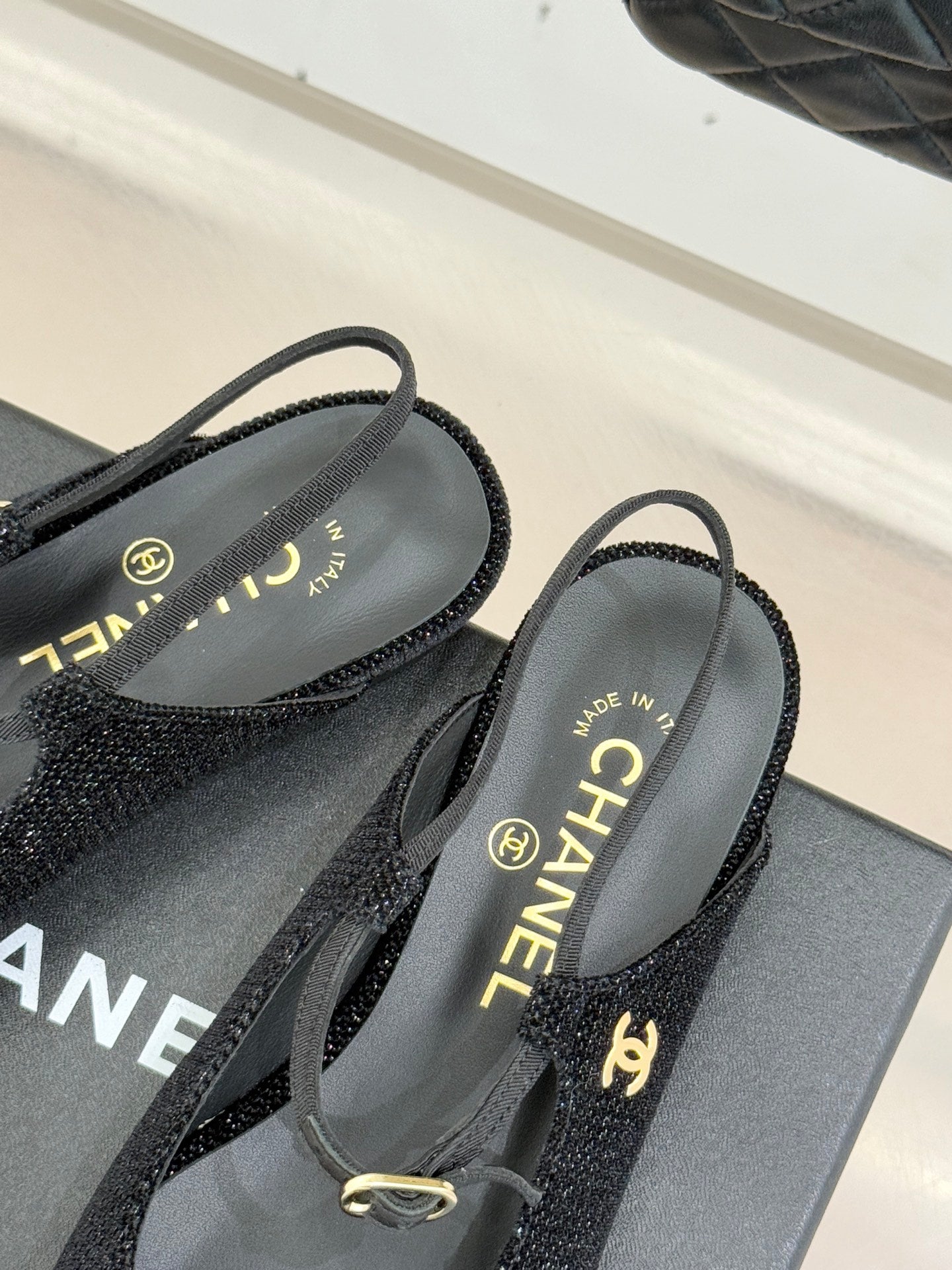 Chanel ladies black slingback flats with 'MADE IN' label and gold hardware