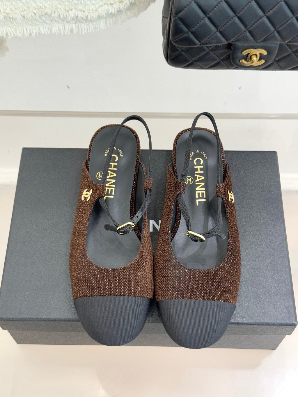 Chanel flats pair, brown textured fabric uppers with dark navy soles and gold buckles