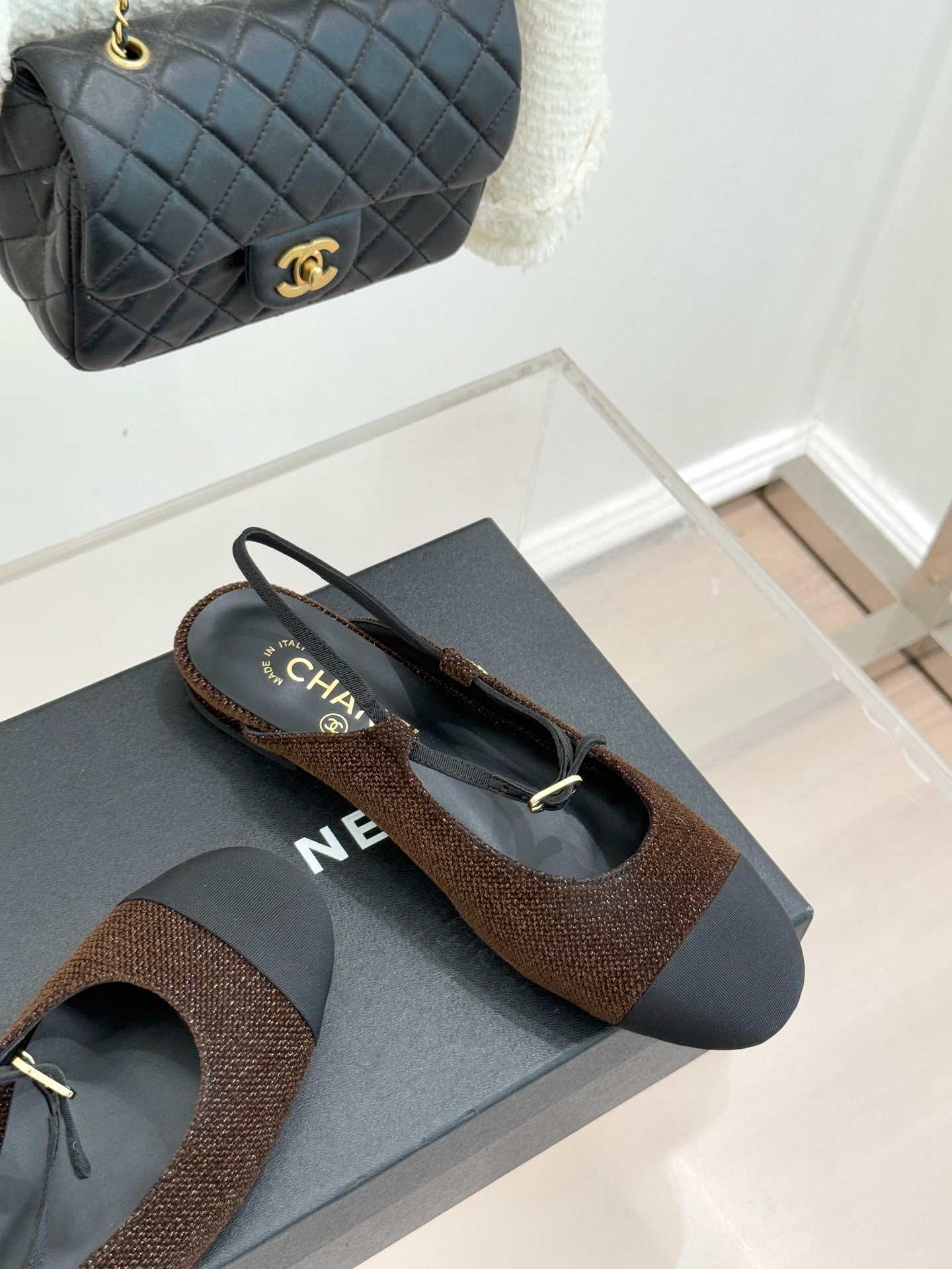 Chanel flats, brown textured upper with dark navy sole and gold CC charm on toe