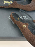 Chanel flats close-up, brown textured fabric with navy insole and gold CC emblem