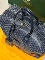 Goyard duffel bag with top handles and shoulder strap, dark blue monogram canvas.