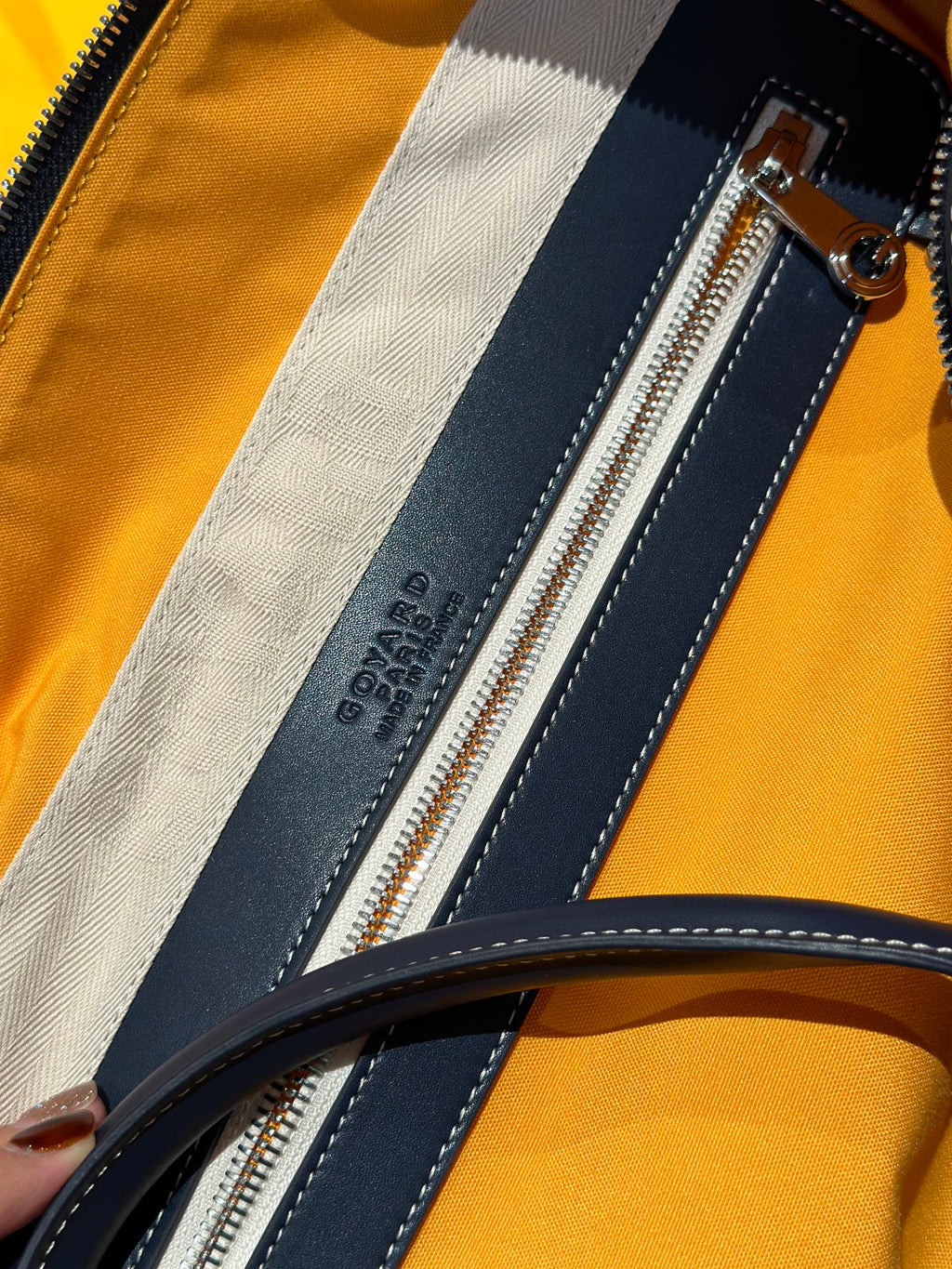 Goyard duffel bag interior zip pocket, dark blue lining with stitched trim stripe.