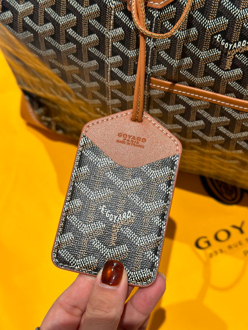 Goyard bag leather zipper pull and key fob on patterned canvas with tan trim