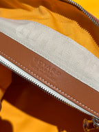 Goyard bag leather trim with stamped logo along the zipper seam