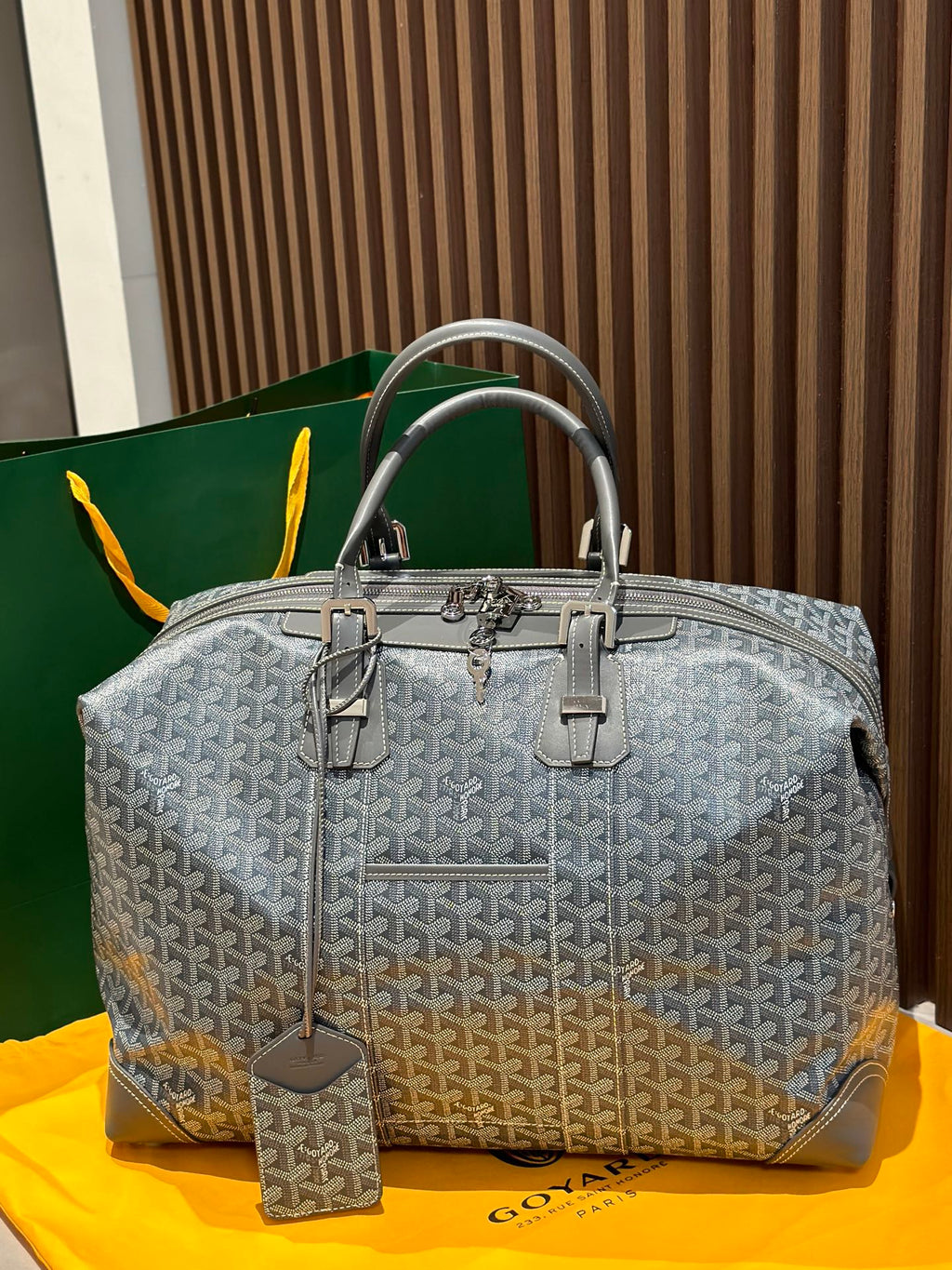 Goyard patterned duffel bag in light gray with dual top handles and front hardware