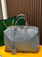 Goyard patterned duffel bag in light gray with dual top handles and front hardware