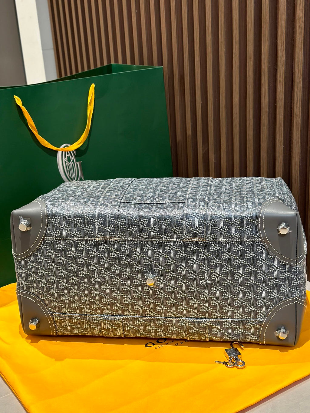 Goyard monogram duffel bag in light gray with shoulder strap and corner tabs