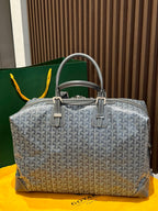 Goyard patterned duffel bag in light gray with dual handles and front clasp hardware
