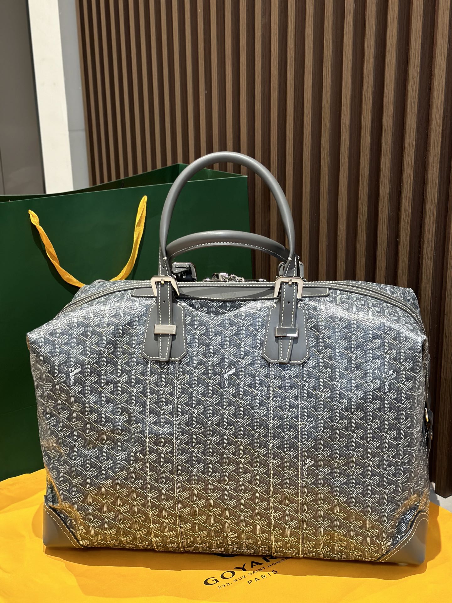 Goyard patterned duffel bag in light gray with dual handles and front clasp hardware