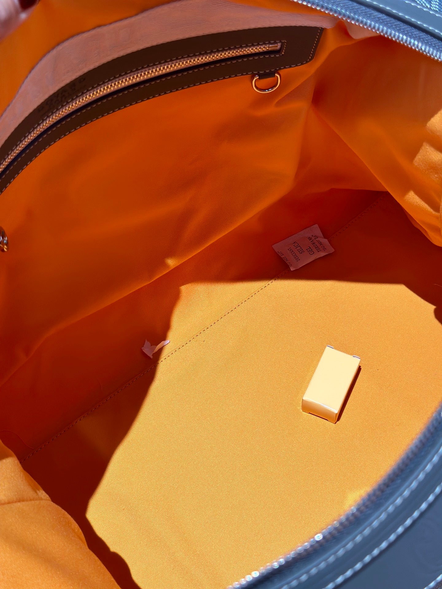 Goyard duffel bag interior lining with small brand tag and flat pocket
