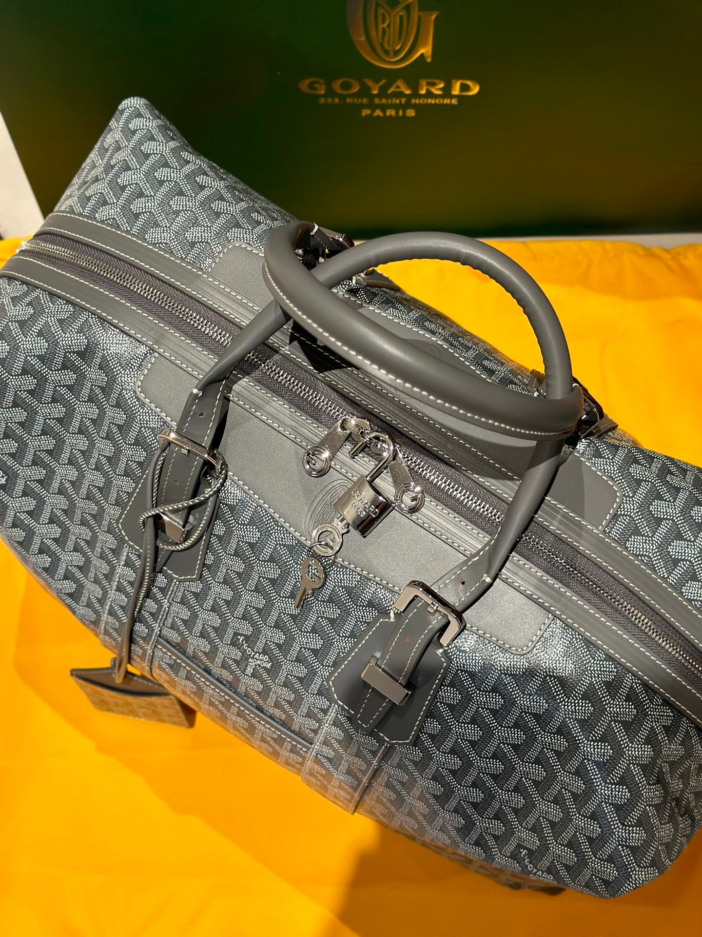 Goyard monogram duffel bag in light gray with top handle and side strap