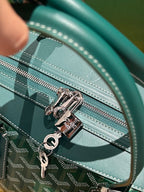 Close-up of green patterned duffel bag zipper with silver pull and trim