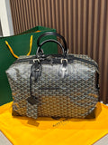 Goyard patterned travel bag with top handles and black trim, front zip pocket