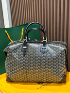 Goyard patterned travel bag with two top handles and front zip panel, black trim