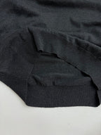 Dark gray ribbed sweater hem and sleeve cuff, knit texture visible