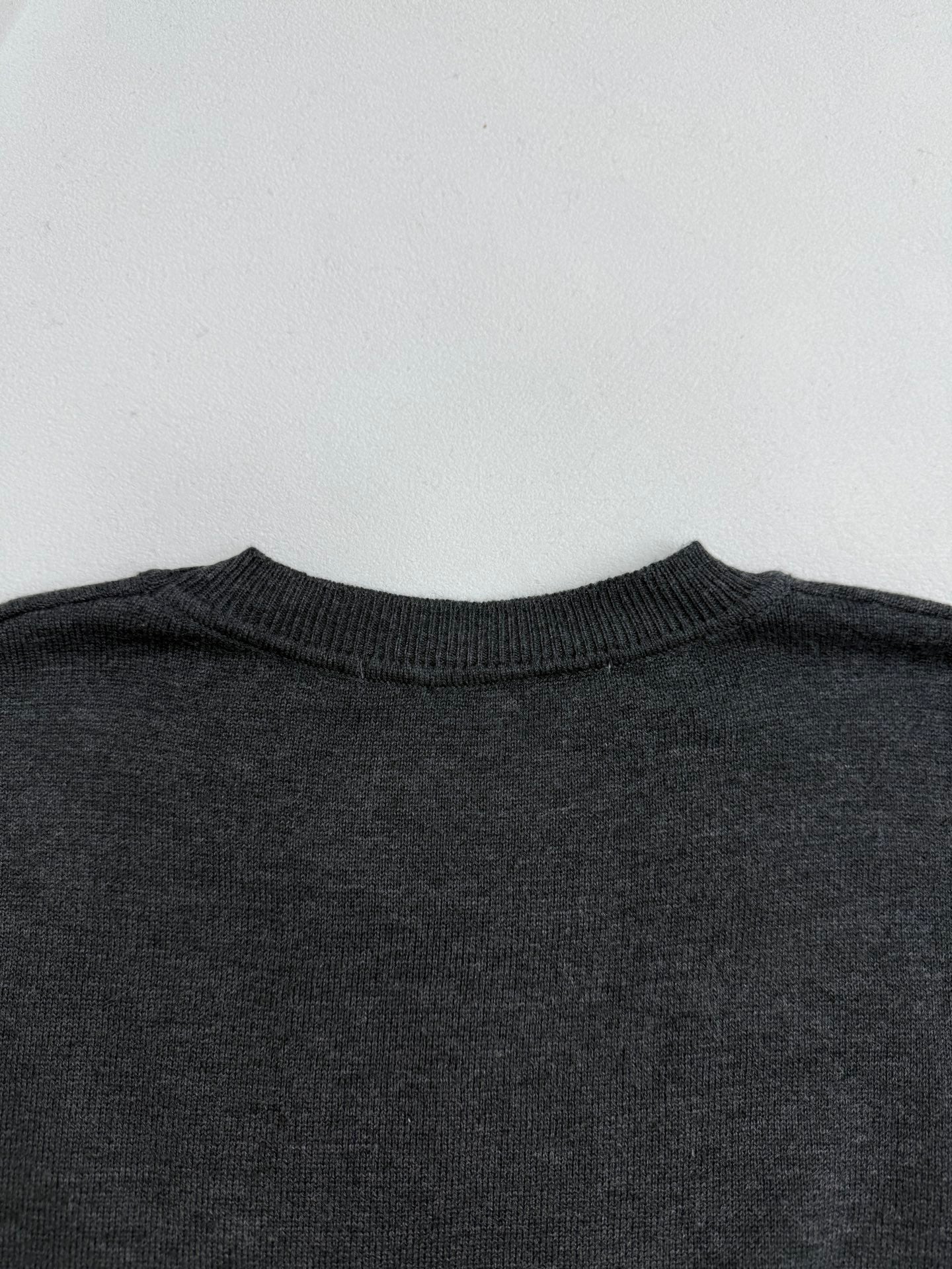 Dark gray crewneck sweater collar ribbing, neckline detail