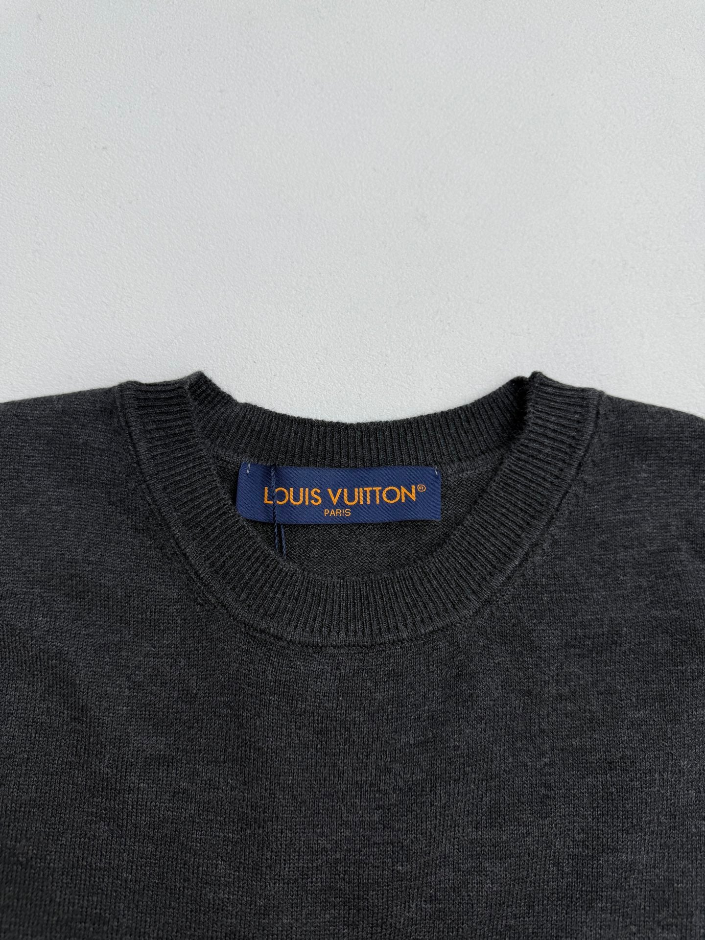 Louis Vuitton crewneck sweater neckline with brand label on dark gray knit