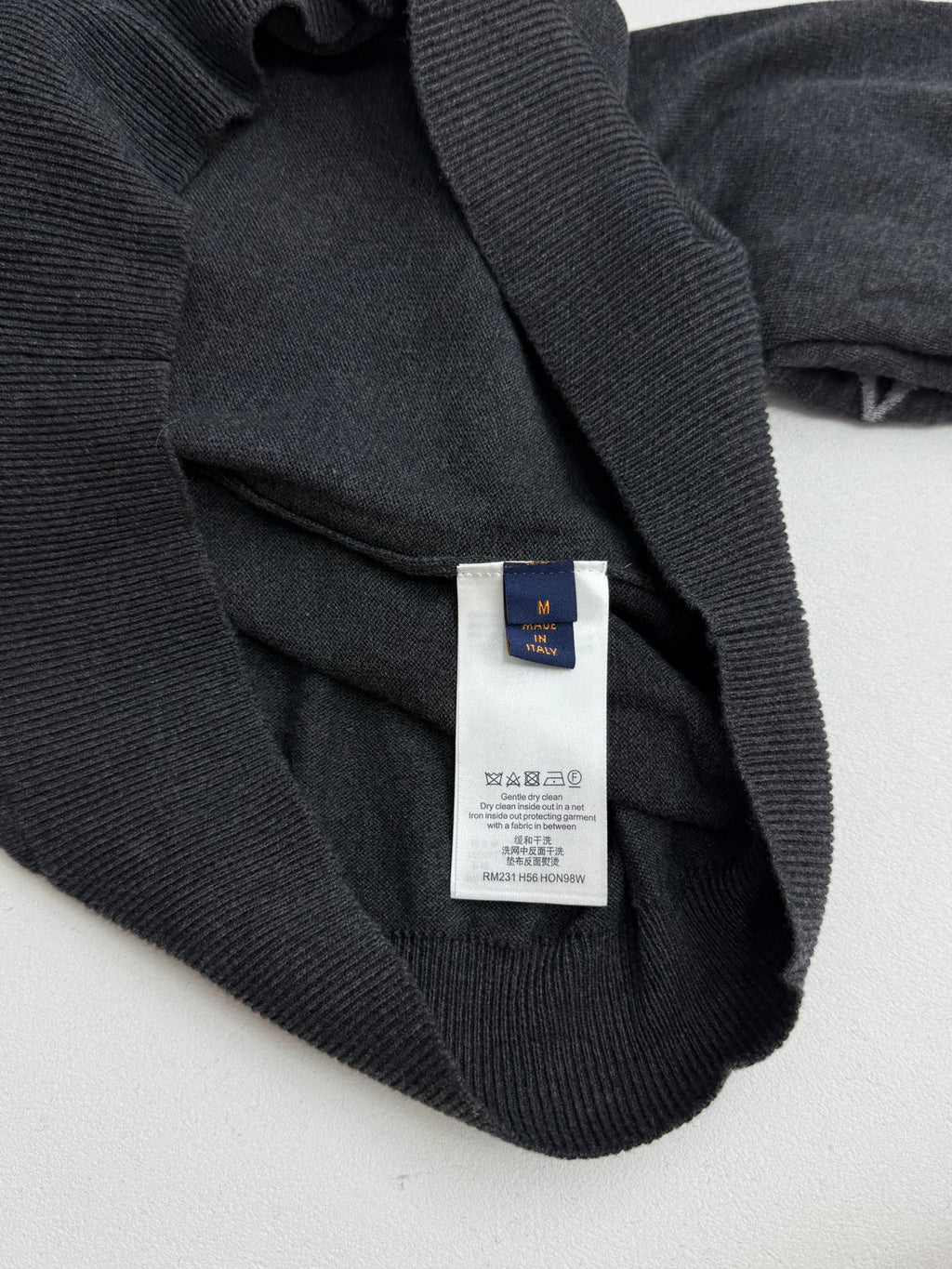 Dark gray sweater care label inside neckline area with Louis Vuitton tag