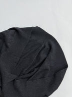 Dark gray sweater sleeve and shoulder seam with textured knit pattern