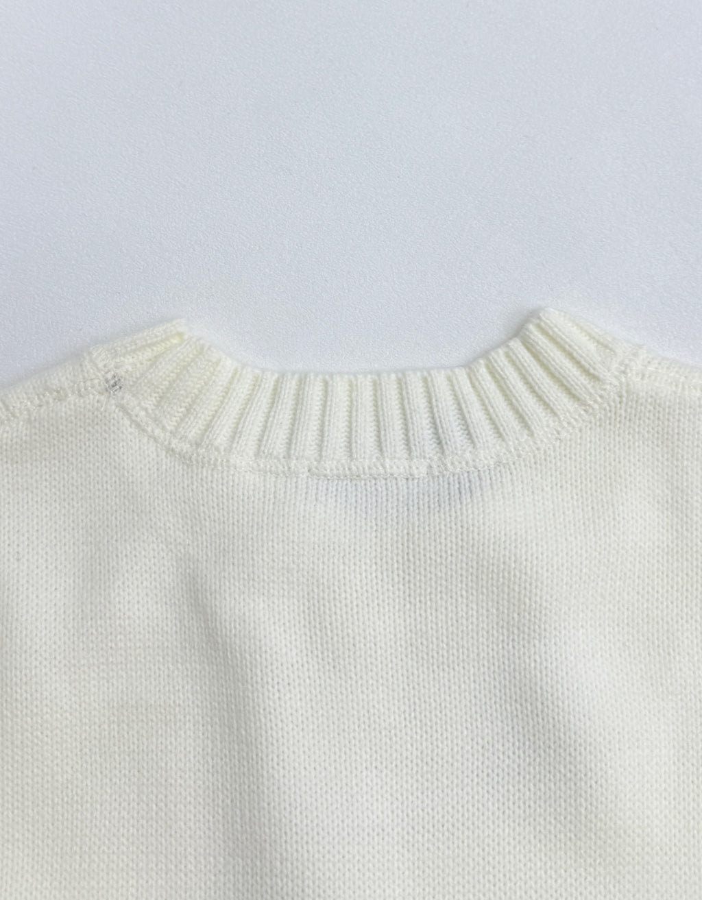 Back view of long-sleeve knit sweater with ribbed crew neckline in pale yellow