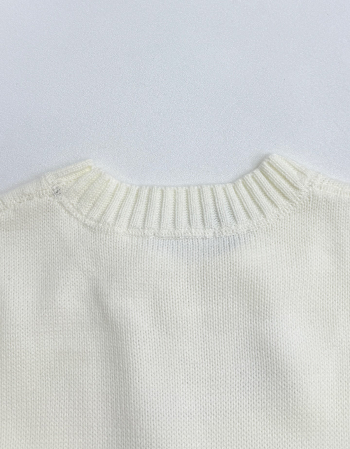 Back view of long-sleeve knit sweater with ribbed crew neckline in pale yellow