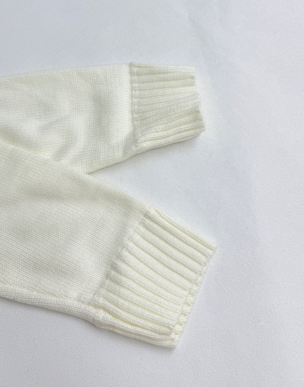 Long-sleeve knit sweater sleeve and ribbed cuff in pale yellow