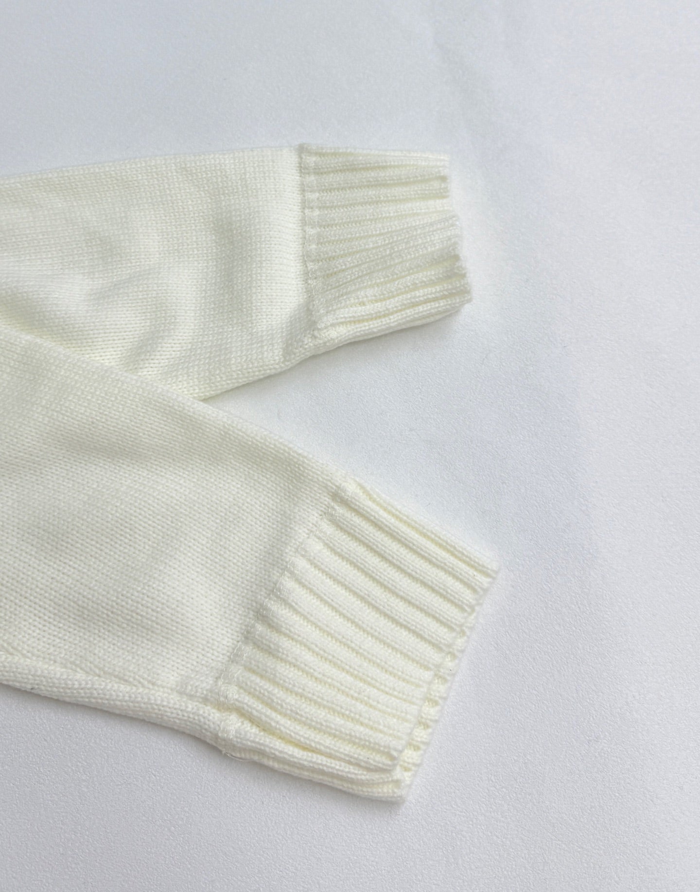 Long-sleeve knit sweater sleeve and ribbed cuff in pale yellow