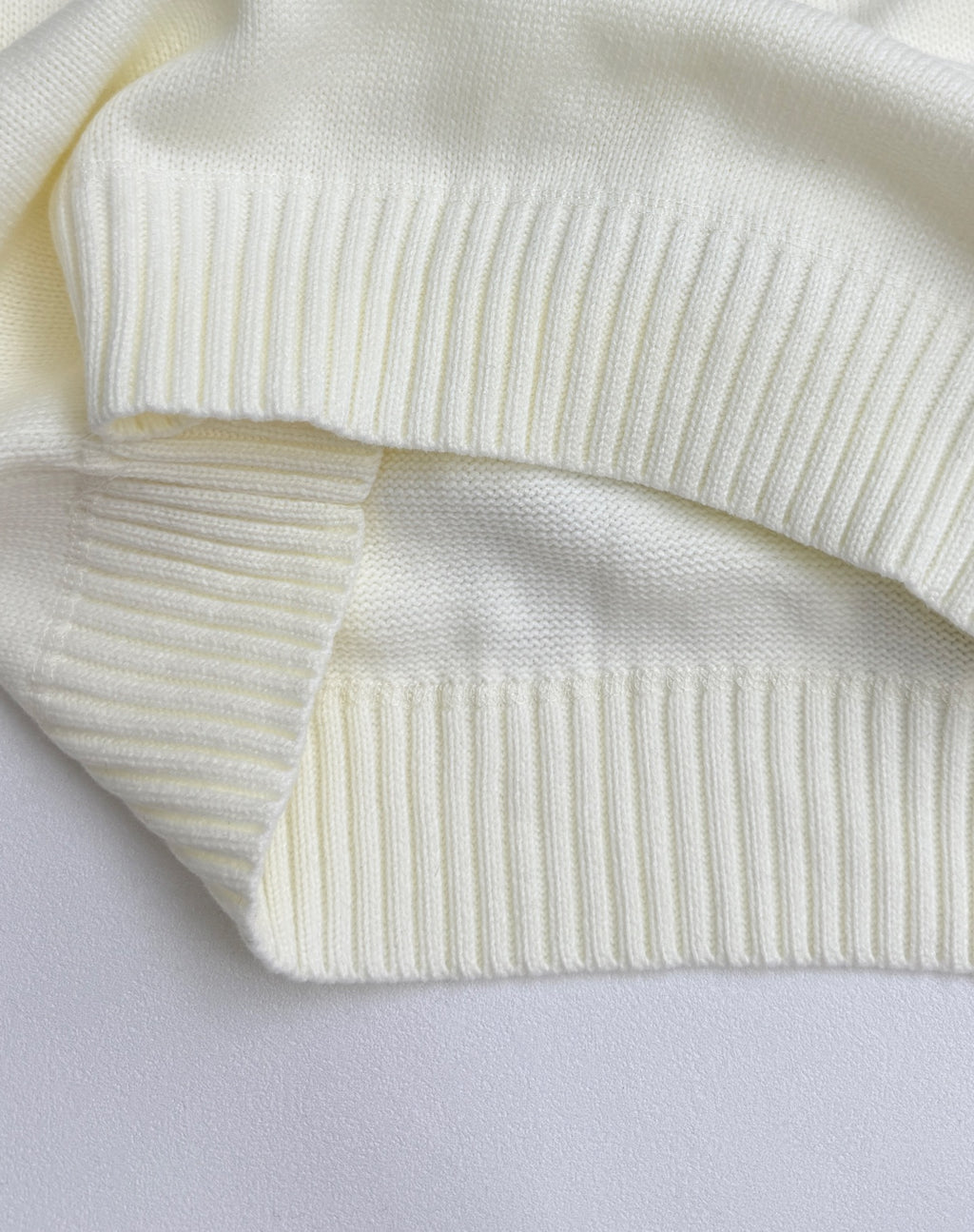 Knit sweater ribbed cuffs and hem bands in pale yellow