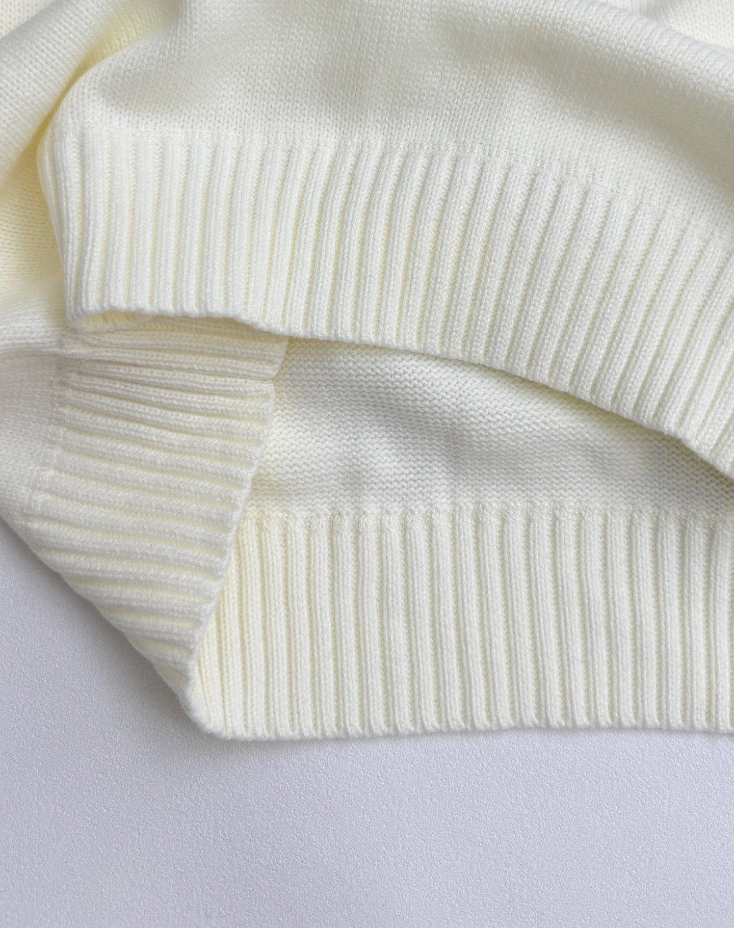 Knit sweater ribbed cuffs and hem bands in pale yellow