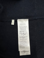 Black knit sweater with white care label at inner back