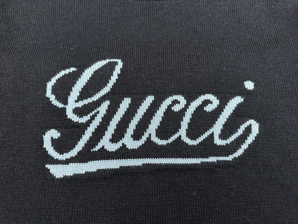 Navy knit sweater with large white 'Gucci' script embroidery