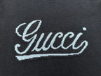 Navy knit sweater with large white 'Gucci' script embroidery