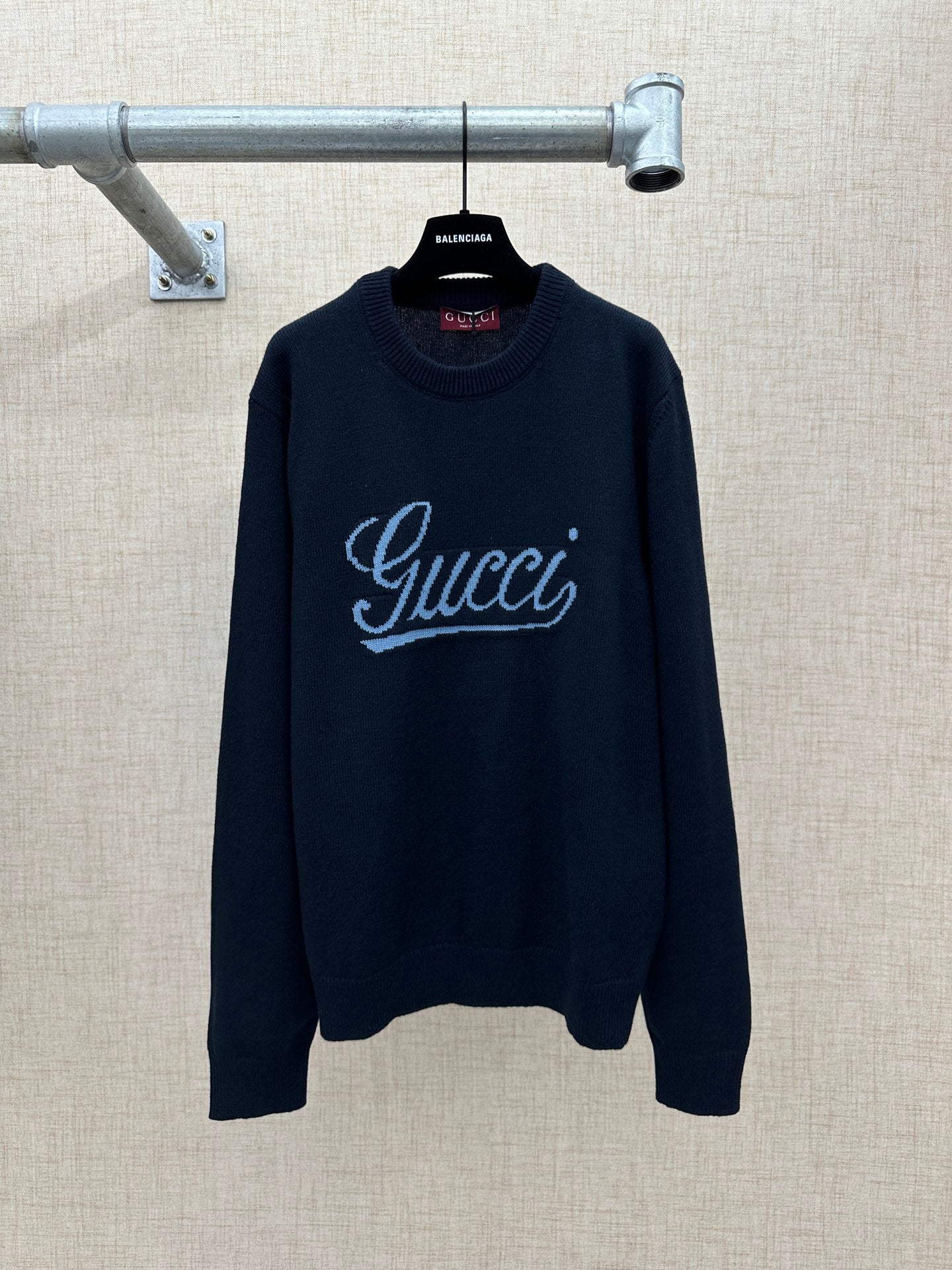 Navy knit sweater with 'Gucci' script logo and ribbed crew neckline