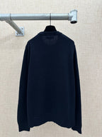 Navy knit sweater with ribbed crew neckline and relaxed back hem