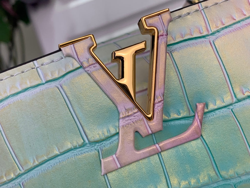 Louis Vuitton handbag monogram hardware detail on pastel pink and blue croc texture