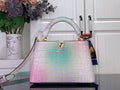 Louis Vuitton handbag in pastel pink with iridescent blue croc texture, top handles