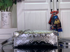 Louis Vuitton silver monogram handbag in profile with top handle and shoulder strap