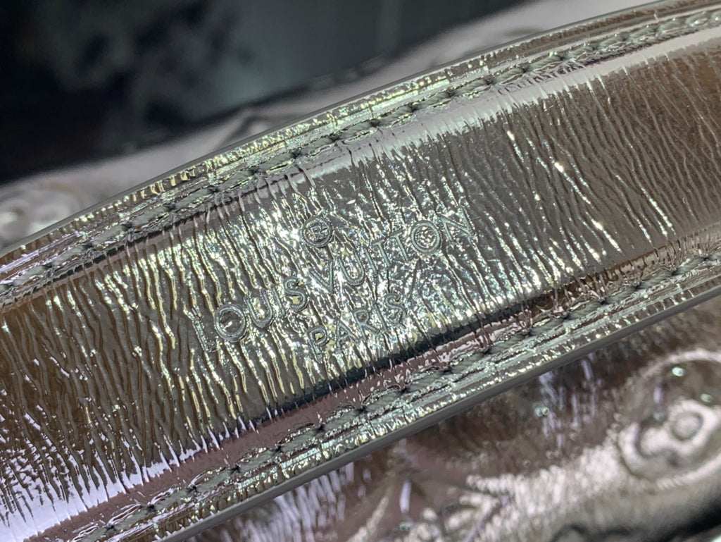 Louis Vuitton silver monogram leather texture close-up with iridescent shine