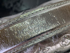 Louis Vuitton silver monogram leather texture close-up with iridescent shine