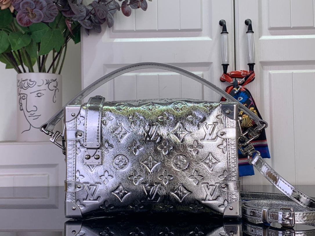 Louis Vuitton metallic silver handbag with monogram pattern, top handles, and shoulder strap