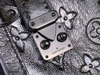 Louis Vuitton silver monogram bag close-up of straps and engraved metal plates