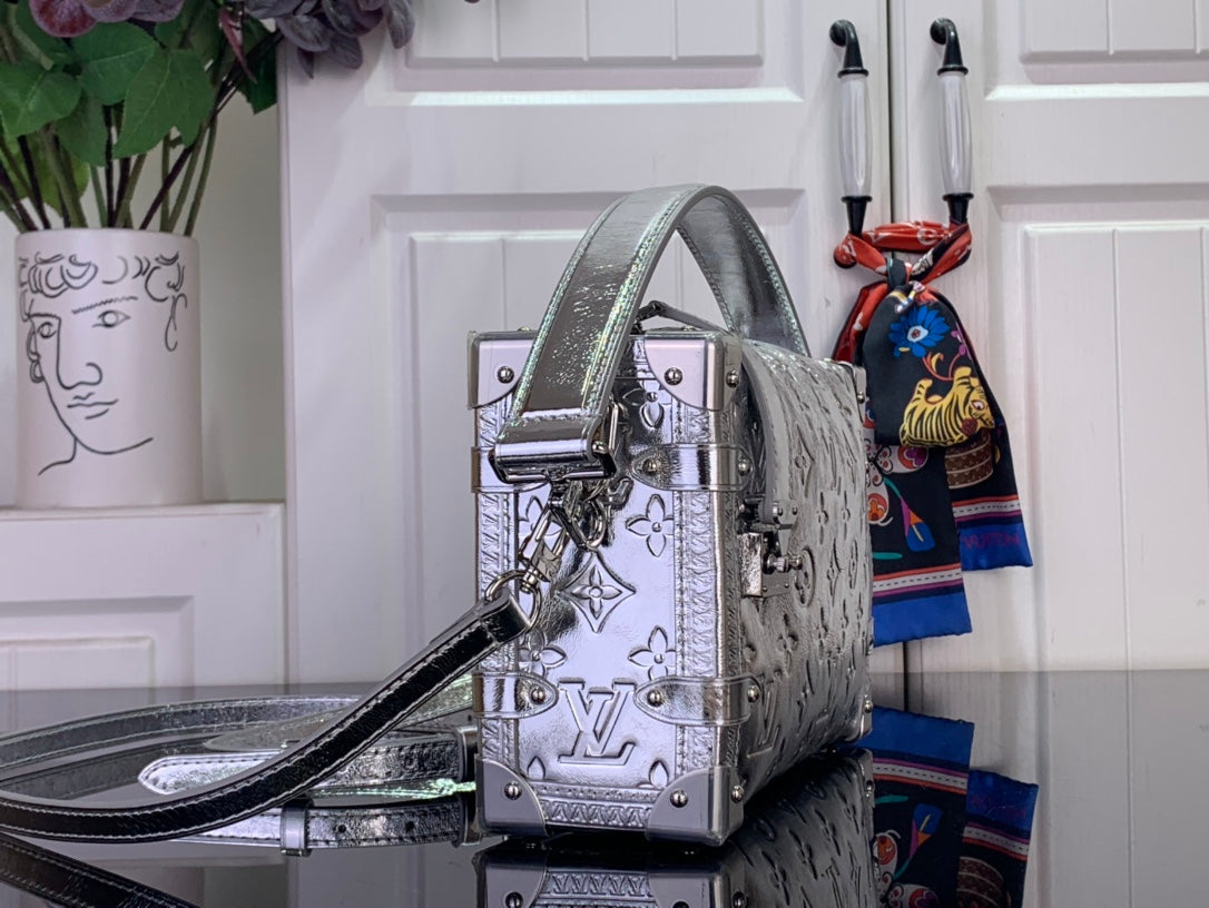 Louis Vuitton silver monogram handbag side view with top handle and shoulder strap
