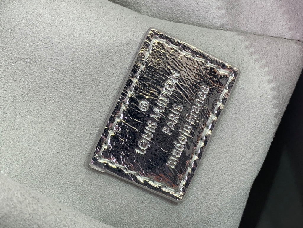 Louis Vuitton engraved hardware plate on textured silver monogram leather